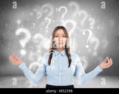 Beautiful business woman with question marks above her head Stock Photo