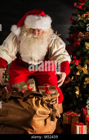 Santa Claus Opening his Bag of Toys isolated on white Stock Photo - Alamy
