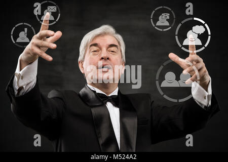 Mature business man pressing social media icon Stock Photo