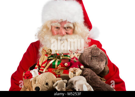 Real Santa Claus carrying big bag full of gifts, isolated on white background Stock Photo