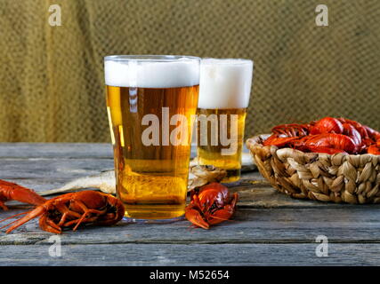 Tasty boiled crayfishes and beer on old table Stock Photo