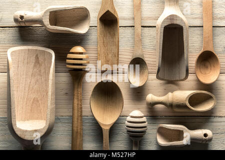 Different wooden utensils on wooden table Stock Photo