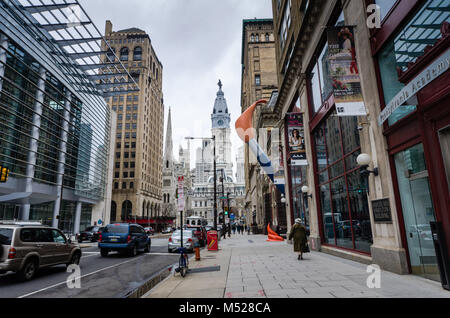 Streetside view of Philadelphia, Pennsylvania with Pennsylvania Academy of Fine Arts in foreground and William Penn statue atop City Hall tower at cen Stock Photo