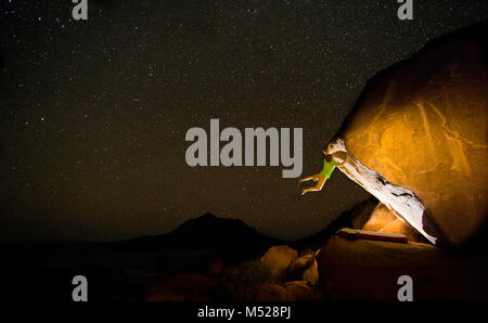 Man bouldering under starry sky at night, Spitzkoppe, Erongo region, Namibia Stock Photo
