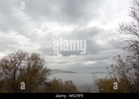 countryside, weather, adventure concept. early morning of autumn in mountains, sky is covered by rainy clouds, they are heavy and grey, hovering above Stock Photo