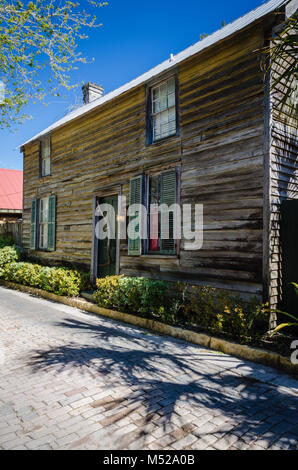 Rustic house with cedar wood siding and farm tool door handle in Historic District of St. Augustine, Florida. Stock Photo
