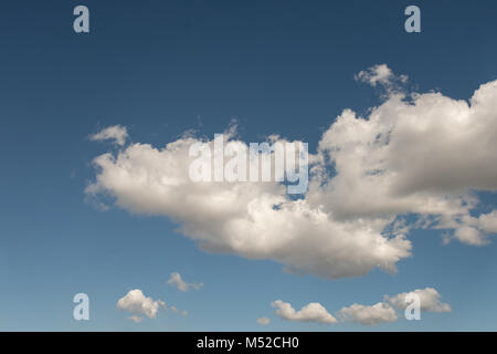 atmospheric phenomenon white, fluffy cumulus clouds against the background of the midday, summer blue sky Stock Photo
