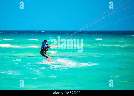 Cayo Guillermo , Cuba - 25 March 2012 : Athletes surfer involved in sports kite windsurfing during high winds and low tide Atlantic Ocean Latin Americ Stock Photo