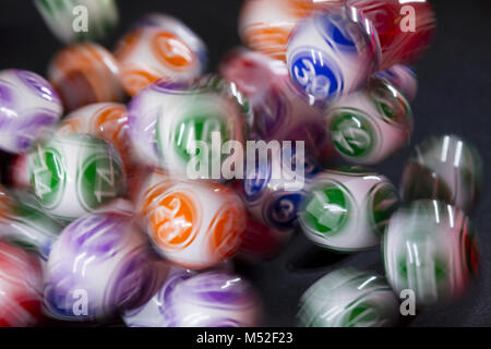 Colourful lottery balls in a machine Stock Photo