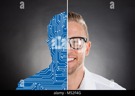 Close-up Of Two Faces Showing Smiling Businessman And Digital Generated Human Figure Against Grey Background Stock Photo