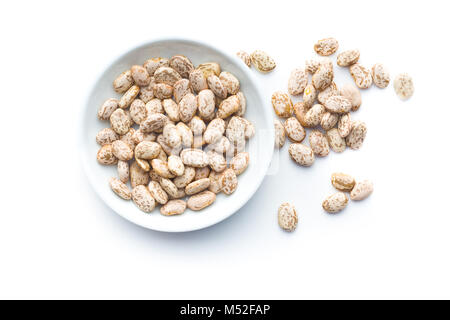 Dried borlotti beans in bowl isolated on white background. Top view. Stock Photo