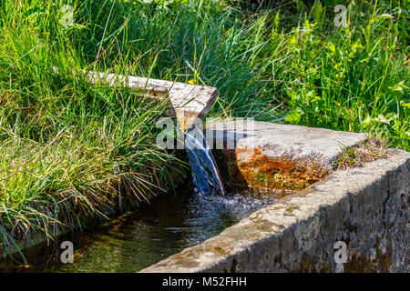 Troughs with running clear water from a spring Stock Photo