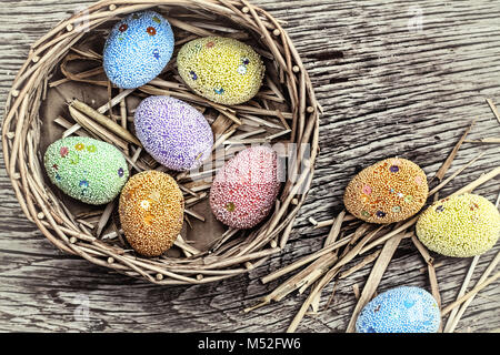 Multicolored Easter eggs in a basket Stock Photo