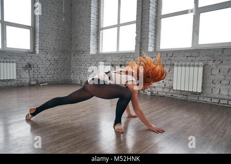 Young beautiful dancer posing on a studio background. Stock Photo