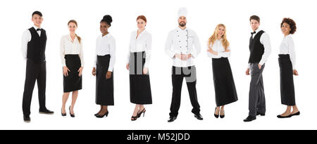 Group Of Happy Restaurant Staffs In A Line Over White Background Stock Photo