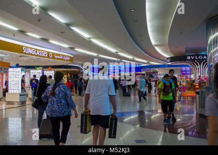 People with baggage walking in Airport duty free area Stock Photo