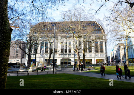 Leicester Square in London with pedestrian walkways, grass areas and Shakespeare statue and fountain. Stock Photo