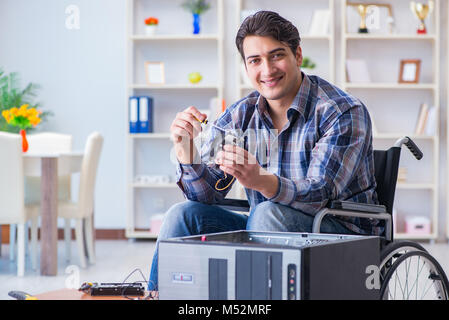 Computer repairman on wheelchair working Stock Photo