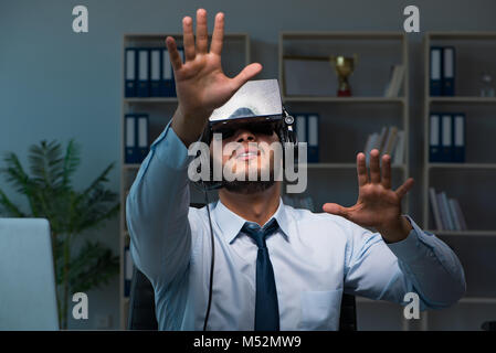 Businessman gamer staying late to play games Stock Photo