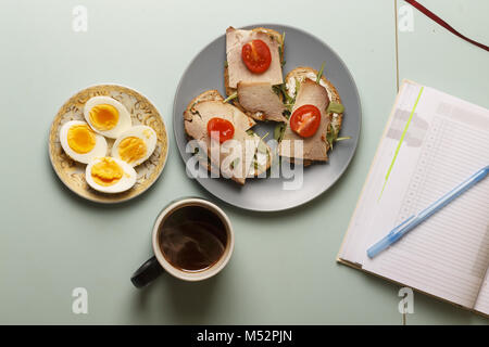 Healthy breakfast.Sandwiches,  hard-boiled eggs, black organic coffee Stock Photo