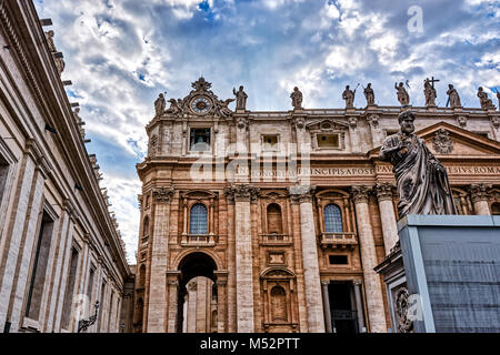 VATICAN CITY, VATICAN - MAY 17, 2017: Detail of the facade of the Papal Basilica of Saint Peter against cloudy sky. Stock Photo