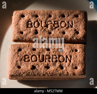 Two bourbon biscuits on a plate. Stock Photo