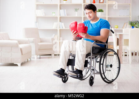 Disabled boxer at wheelchair recovering from injury Stock Photo