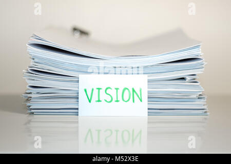 Vision; Stack of Documents on white desk and Background. Stock Photo