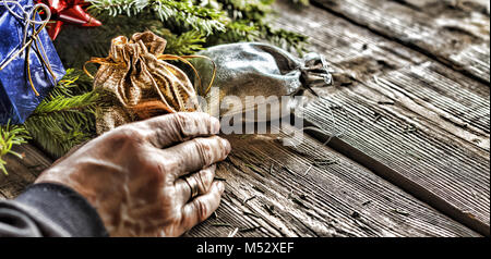 Man puts presents under the Christmas tree. Stock Photo