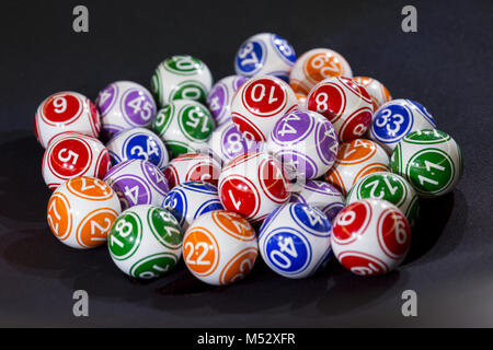 Colourful lottery balls in a machine Stock Photo