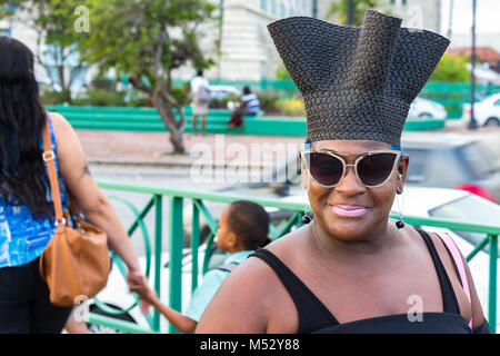 Bridgetown, Barbados - January 31th, 2018: Portrait of native woman wearing sunglasses and a hat looking at camera at the Bridgetown waterfront. Stock Photo