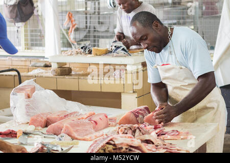 Bridgetown, Barbados - January 31th, 2018: A worker at the Bridgetown Fish Market is preparing salmon fish for sale. Stock Photo