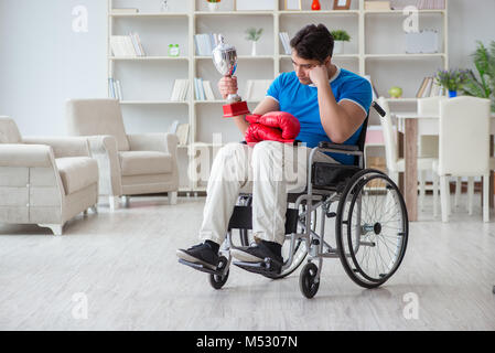 Disabled boxer at wheelchair recovering from injury Stock Photo