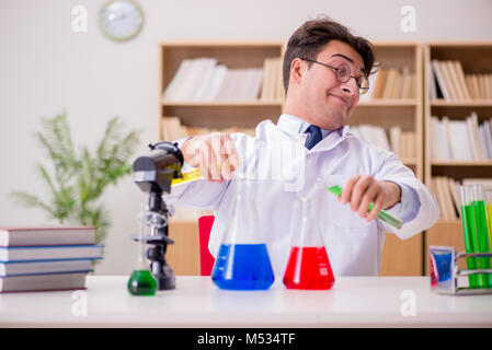 Mad crazy scientist doctor doing experiments in a laboratory Stock Photo