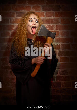 Scary witch on brick background Stock Photo