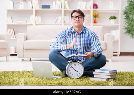 Young handsome man sitting on floor at home Stock Photo