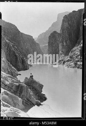 VIEW UP COLORADO RIVER IN GRAND CANYON, LAKE MEAD. MAN POSES NEAR SUPRISE CREEK. 03 NOV 1937.    Grand Canyon Nat Park Historic River Photo. Stock Photo