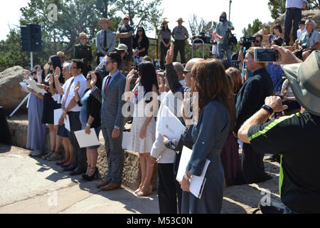 NPS Centennial Grand Canyon Naturalization Ceremony  U.S. Citizenship and Immigration Services (USCIS) teamed with Grand Canyon National Park and the National Park Service (NPS) to welcome 15 new United States citizens representing 12 countries. The ceremony took place August 25th, 2016, the National Park Service's 100th birthday, at 10 am at Mather Point Amphitheater. In honor of the NPS Centennial, USCIS has partnered with the NPS to hold more than 100 naturalization ceremonies on national park sites during 2016. Stock Photo