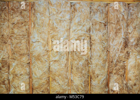 Inside wall insulation in wooden house, building under construction Stock Photo