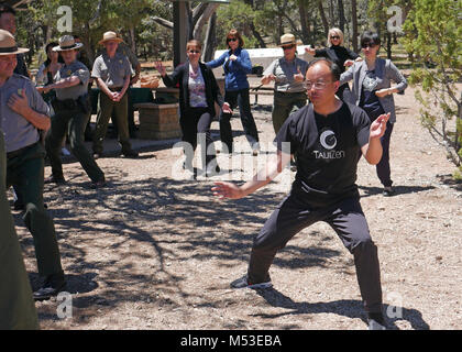 Grand Canyon Renews Sister Park Agreement with China's Yuntaishan World. Yang zhaohui, director of the Tourism Bureau of Wen County, gave a Tai chi lesson for Grand Canyon National Park Staff who were attending the Sister Park signing ceremony.  Grand Canyon National Park and Yuntaishan Geopark from the Henan province of China renewed their five-year Sister Park Agreement on Tuesday, May 23, 2017.  The agreement allows for an intellectual exchange, international coope Stock Photo