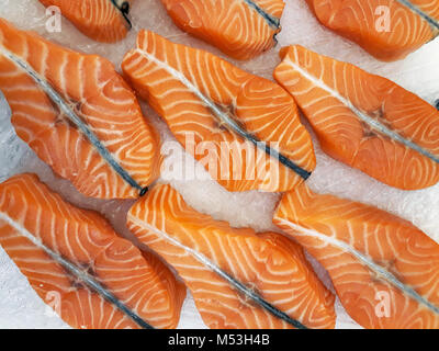 Fresh raw salmon steaks on ice at the market Stock Photo