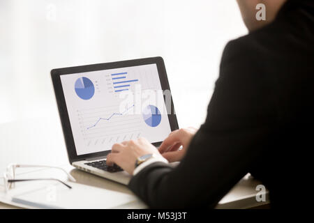 Employee working on annual report or presentation Stock Photo