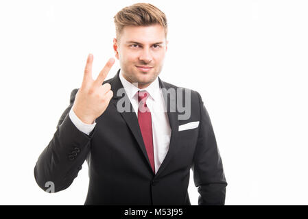 Portrait of handsome corporate business man showing number two isolated on white background with copyspace advertising area Stock Photo