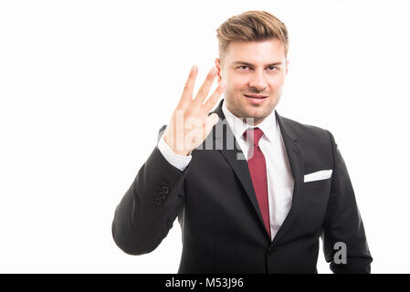Portrait of handsome corporate business man showing number three isolated on white background with copyspace advertising area Stock Photo