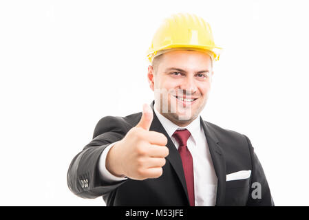 Constructor wearing suit and hardhat showing like gesture isolated on white background with copyspace advertising area Stock Photo