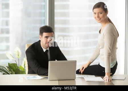 Smiling colleagues working together in office Stock Photo