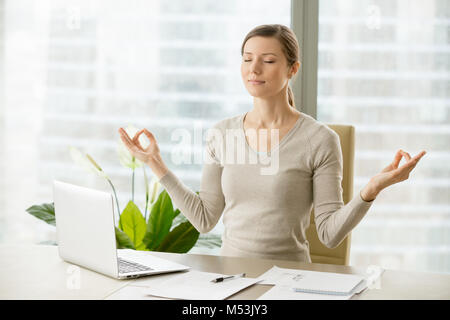 Calm businesswoman relaxing with breath gymnastics Stock Photo