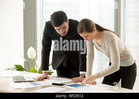 Female and male designers discussing colors scheme Stock Photo