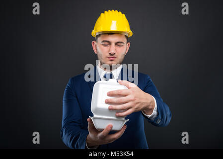 Successful constructor in his lunch break didin't like the food he ordered Stock Photo