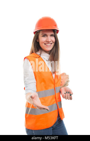 Young beautiful woman engineer in protection uniform doing handshake gesture Stock Photo